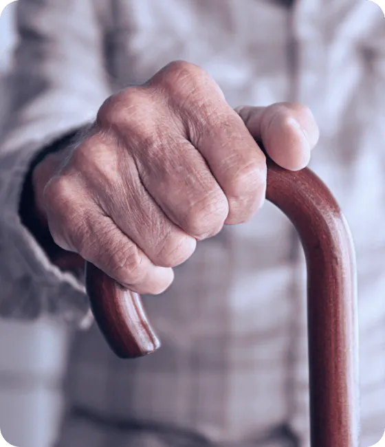 old man hand holding walking stick 1